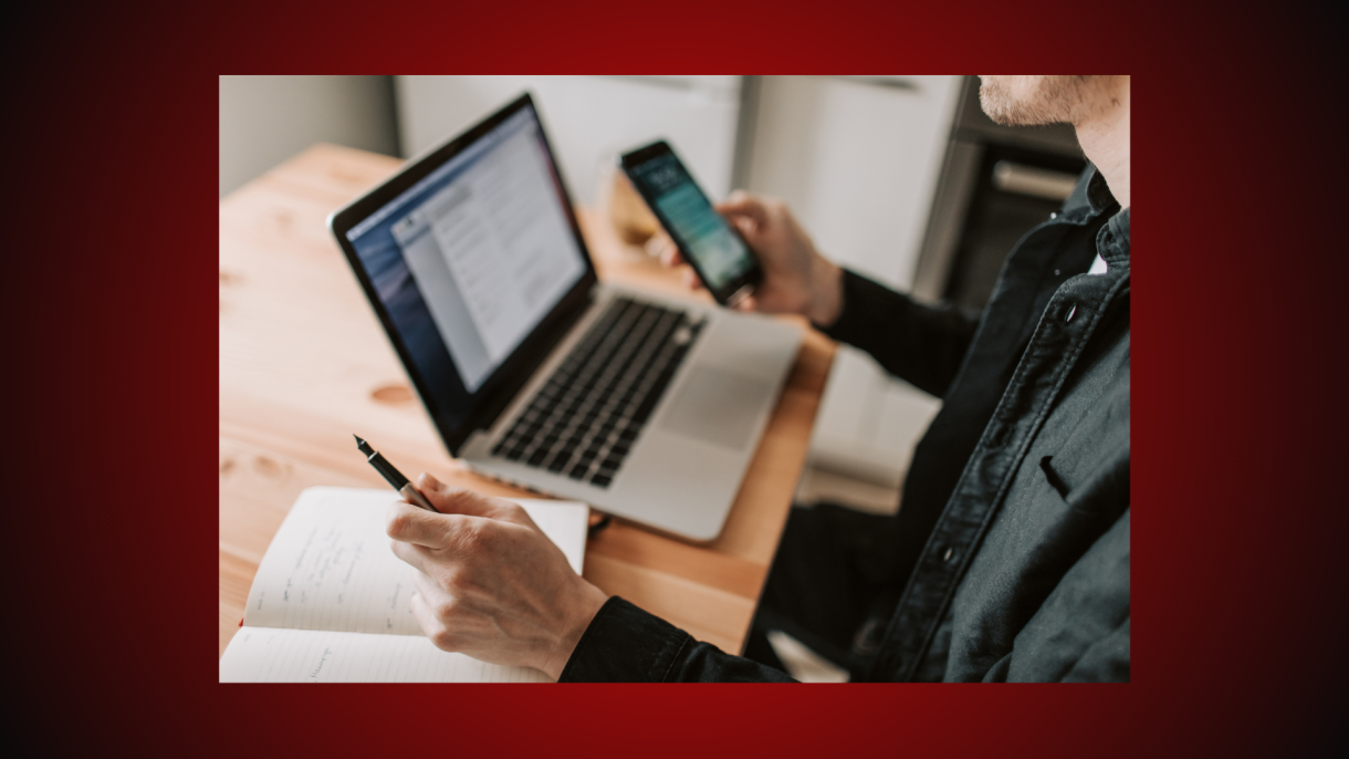 Person on the computer, looking at cell phone instructional content